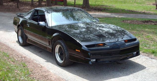 This is what this boy's 1985 black Pontiac Firebird muscle car looked like